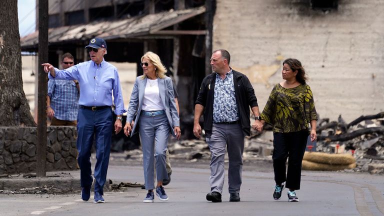 President Joe Biden and first lady Jill Biden walk with Hawaii Gov. Josh Green and his wife Jaime Green as they visit areas devastated by the Maui wildfires, Monday, Aug. 21, 2023, in Lahaina, Hawaii. (AP Photo/Evan Vucci)