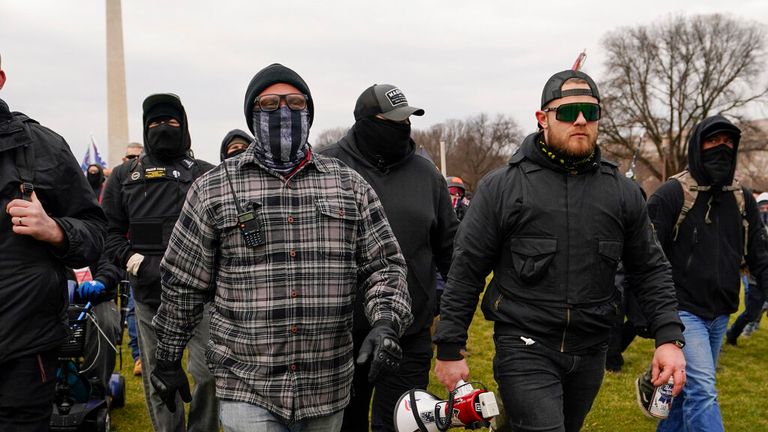 Proud Boy members Joseph Biggs (L) and Ethan Nordean walk toward the US Capitol in Washington on 6 January 2021