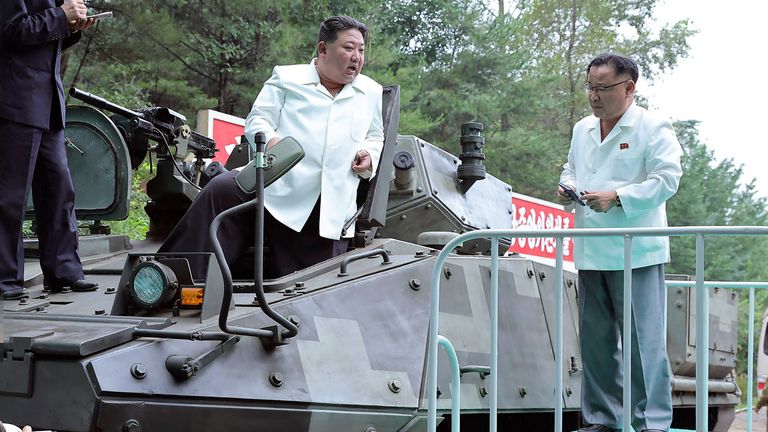 Kim Jong Un rides on an  vehicle during his   visit to a military factory in North Korea. 
Pic:Korean Central News Agency/AP