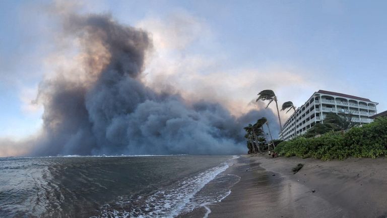 Smoke billows near Lahaina as wildfires driven by high winds destroy a large part of the historic town of Lahaina, Hawaii, U.S. August 9, 2023. Dustin Johnson/Handout via REUTERS THIS IMAGE HAS BEEN SUPPLIED BY A THIRD PARTY. REFILE - REMOVING KAHULUI
