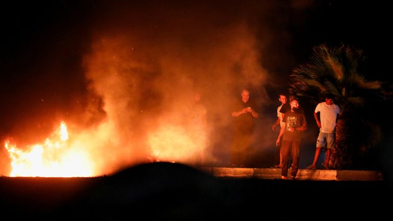 Demonstrators burn tires in protest against the meeting between the foreign affairs ministers of Libya and Israel held last week in Italy, in Tripoli, Libya, August 28, 2023. REUTERS/Hani Amara
