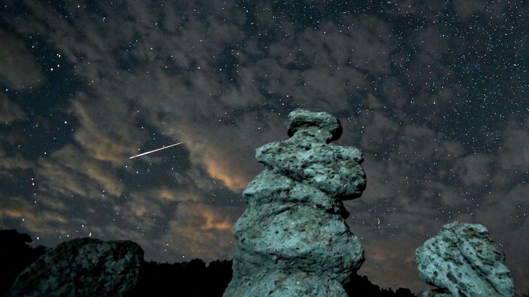 A long exposure photo shows meteor streaks crossing the night sky over the stone dolls in Kuklica, Republic of North Macedonia, 13 August 2023. The Perseid meteor shower occurs every year in August when the Earth passes through debris and dust of the Swift-Tuttle comet.

