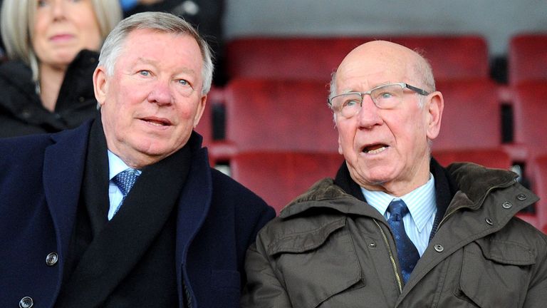 Manchester United manager Sir Alex Ferguson takes his seat next to Sir Bobby Charlton 