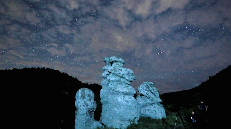 A meteor streaks during the Perseid meteor shower in the night sky over the village of Kuklici, known for its hundreds of naturally formed stones which resemble human beings, near Kratovo, North Macedonia August 13, 2023.REUTERS/Ognen Teofilovski