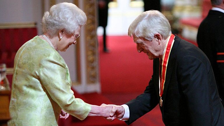 Sir Michael Parkinson receives his Knighthood from Britain&#39;s Queen Elizabeth II at Buckingham Palace.