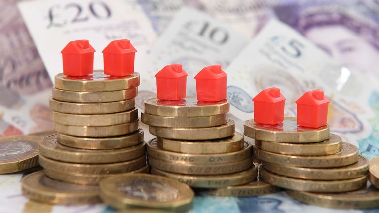 File photo dated 12/09/18 of models houses on a pile of coins and bank notes. PA