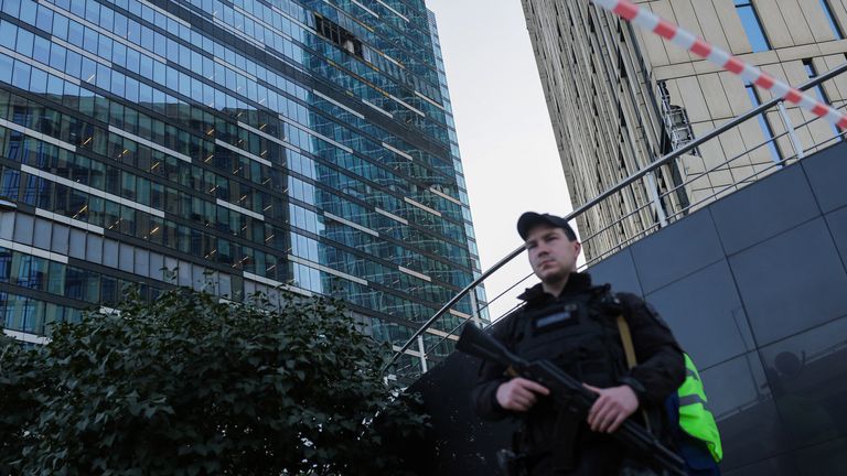 A security officer stands guard near a damaged office building in the Moscow City following a reported Ukrainian drone attack in Moscow Russia, August 1, 2023. REUTERS/Evgenia Novozhenina
