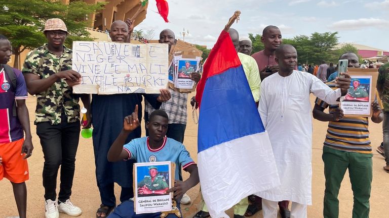 Supporters of Niger&#39;s ruling junta hold a Russian flag in Niamey. Pic: AP