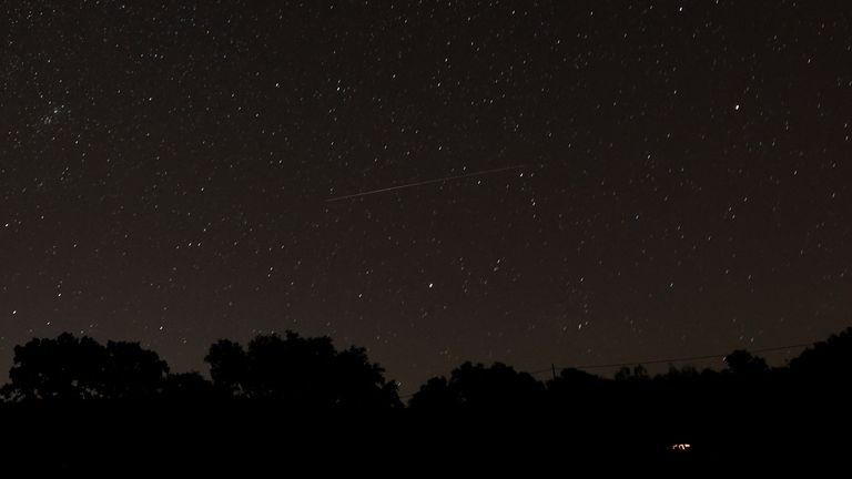 A meteor streaks in the night sky during the annual Perseid meteor shower in Ronda, Spain August 12, 2023. REUTERS/Jon Nazca