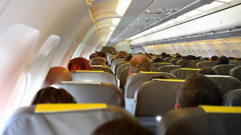 Interior view of commercial airplane cabin with rows of passengers sitting in their seats during flight. Pic: iStock