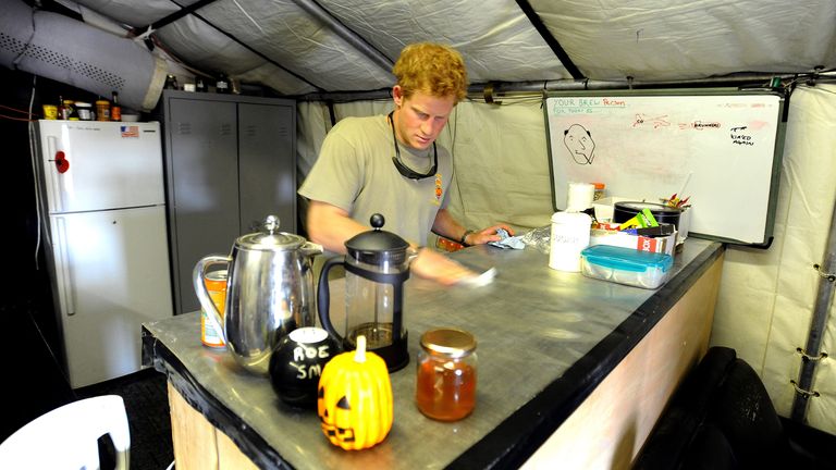 Britain's Prince Harry cleans the kitchen work-top during his 12 hour VHR (very high ready-ness) shift, at the British controlled flight-line in Camp Bastion southern Afghanistan in this photograph taken November 3, 2012, and released January 22, 2013. The Prince, who is serving as a pilot/gunner with 662 Squadron Army Air Corps, is on a posting to Afghanistan that runs from September 2012 to January 2013. Photograph taken November 3, 2012. REUTERS/John Stillwell/Pool (AFGHANISTAN - Tags: MILITA