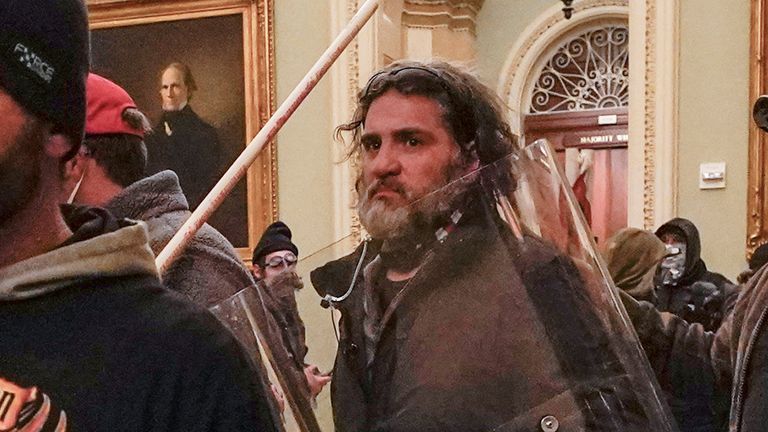 FILE - Rioters, including Dominic Pezzola, center with police shield, are confronted by U.S. Capitol Police officers outside the Senate Chamber inside the Capitol, Wednesday, Jan. 6, 2021, in Washington. A federal jury is scheduled to hear a second day of attorneys... closing arguments in the landmark trial for former Proud Boys extremist group leaders charged with plotting to violently stop the transfer of presidential power after the 2020 election.(AP Photo/Manuel Balce Ceneta, File)