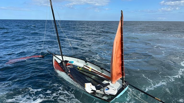 The sinking yacht of a lone sailor who was rescued after a lifeboat volunteer heard his muffled cries for help