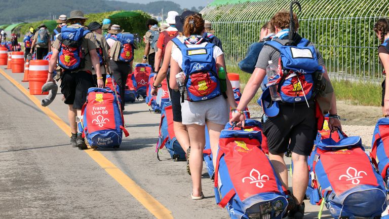 British scout members leave the World Scout Jamboree campsite in Buan, South Korea, Sunday, Aug. 6, 2023.  South Korea is preparing to evacuate tens of thousands of scouts from a coastal jamboree site as Tropical Storm Khanun looms, world scouting officials said Monday. (Choe Young-soo/Yonhap via AP)