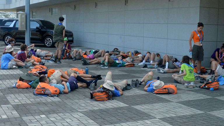 Attendees of the World Scout Jamboree lie down. Pic: AP