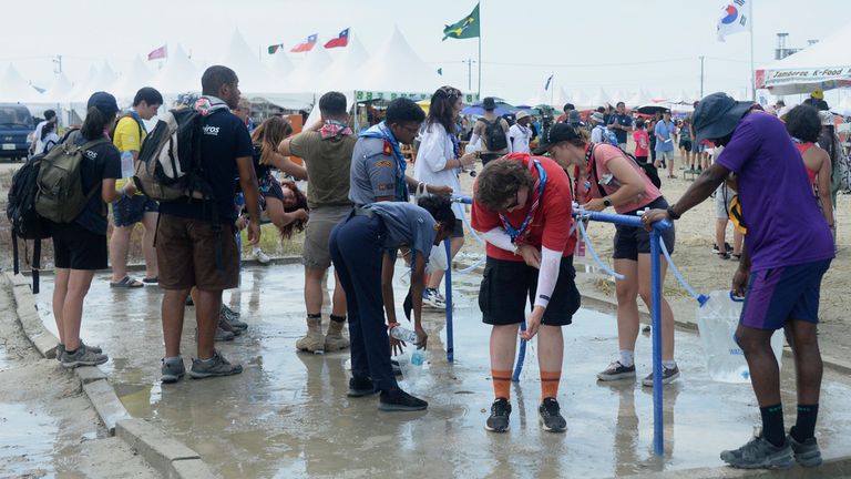 Attendees of the World Scout Jamboree cool off. Pic: AP