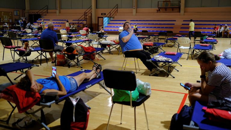 People rest inside a pavilion after being evacuated in the village of Perdoma, as wildfires rage out of control on the island of Tenerife, Canary Islands, Spain August 19, 2023. REUTERS/Nacho Doce