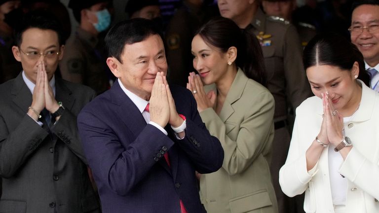 Thailand&#39;s former Prime Minister Thaksin Shinawatra, foreground, with, from left, his son Phantongtae, his daughters Pinthongta and Paetongtarn, arrives at Don Muang airport in Bangkok, Thailand, Tuesday, Aug. 22, 2023. (AP Photo/Sakchai Lalit)