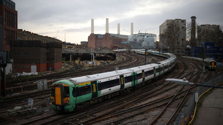A train passes in front of Battersea Power Station as it enters Victoria station in London, Britain, February 10, 2023. REUTERS/Henry Nicholls