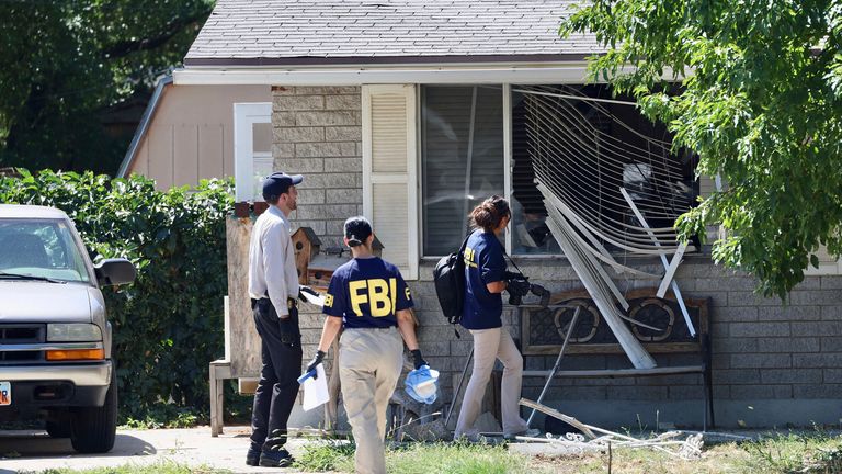 Law enforcement investigate the scene of a shooting involving the FBI Wednesday, Aug. 9, 2023 in Provo, Utah.  A  man accused of making threats against President Joe Biden was shot and killed by FBI agents hours before the president was expected to land in the state Wednesday, authorities said. (Laura Seitz/The Deseret News via AP)