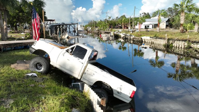 A vehicle is seen in a canal after the arrival of Hurricane Idalia in Horseshoe Beach, Florida, U.S., August 31, 2023. REUTERS/Julio Cesar Chavez
