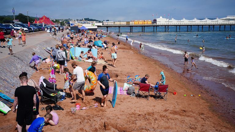 File photo dated 10/08/23 of people enjoying the sun on Paignton beach in Torbay. Tropical air could make parts of the UK hotter than California at the end of next week with temperatures possibly soaring past 30C, after heavy rain lashes the country. Issue date: Saturday August 12, 2023.