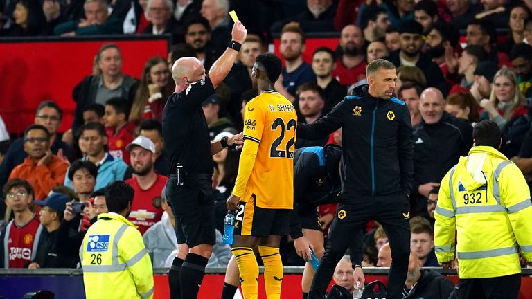 Gary O'Neil (right) is shown a yellow card by referee Simon Hooper
