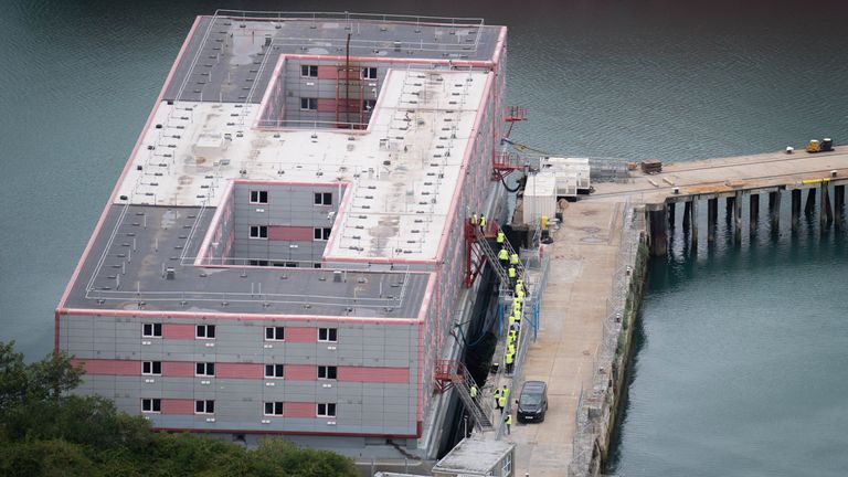 Workers return to the Bibby Stockholm accommodation barge at Portland Port in Dorset after what is believed to be a fire drill. The Home Office have said around 50 asylum seekers would board the Bibby Stockholm, with the numbers rising to its maximum capacity over the coming months, despite safety concerns being raised. Picture date: Thursday August 3, 2023.