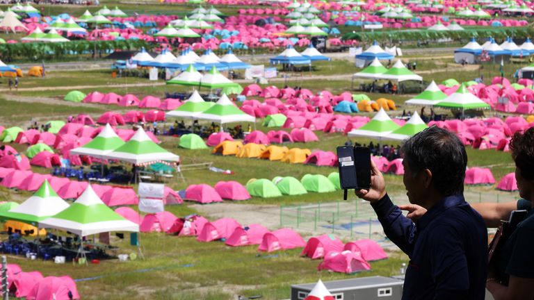 A resident films the camping site for the 25th World Scout Jamboree in Buan, South Korea, August 4, 2023. REUTERS/Kim Hong-Ji
