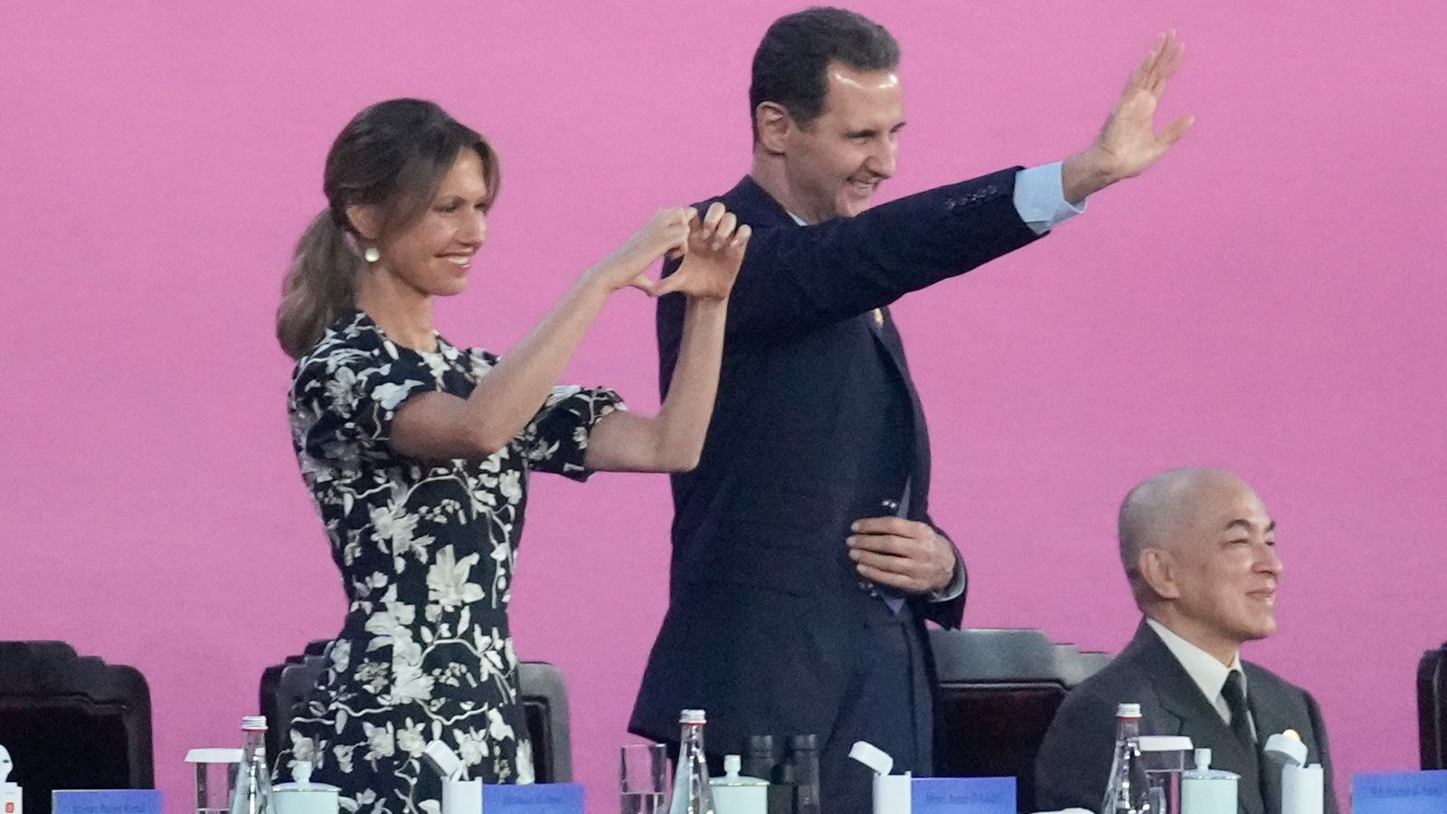 Syria's Bashar al Assad and wife laugh and wave at Asian Games opening ceremony amid China talks