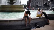 People cool off by a  water fountain during a heatwave, at Trafalgar Square in London, Britain, July 19, 2022. REUTERS/Henry Nicholls.