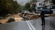 A person stands on a road which collapsed due to the impact of storm Daniel, near a nursing home in the city of Volos, Greece, September 6, 2023. REUTERS/Louisa Gouliamaki
