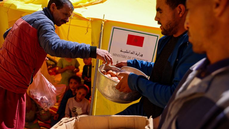 People receive food, in the aftermath of a deadly earthquake, in Adassil, Morocco, September 11, 2023. REUTERS/Nacho Doce
