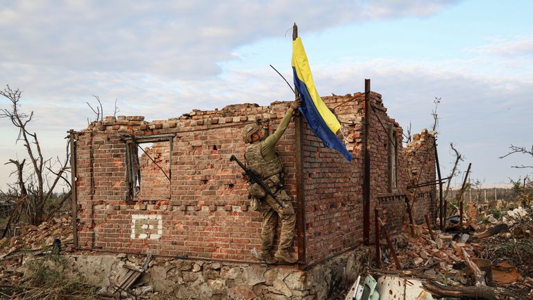 An assault unit commander from the 3rd Assault Brigade who goes by the call sign &#39;Fedia&#39; raises the Ukrainian flag as a symbol of liberation of the frontline village of Andriivka, Donetsk region, Ukraine, Saturday, Sept. 16, 2023. The 3rd Assault Brigade announced Friday they had recaptured the war-ravaged settlement which lies 10 kilometers (6 miles) south of Russian-occupied city of Bakhmut, in the country&#39;s embattled east. (AP Photo/Alex Babenko)