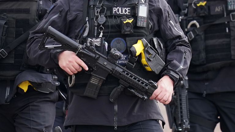 Armed police officers patrol the Mall ahead of the King&#39;s coronation ceremony