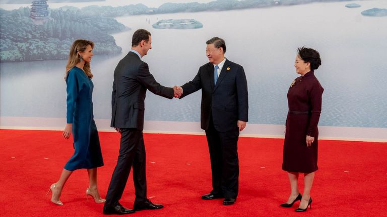 Bashar al Assad greets Xi Jinping (right) ahead of the opening of the Asian Games