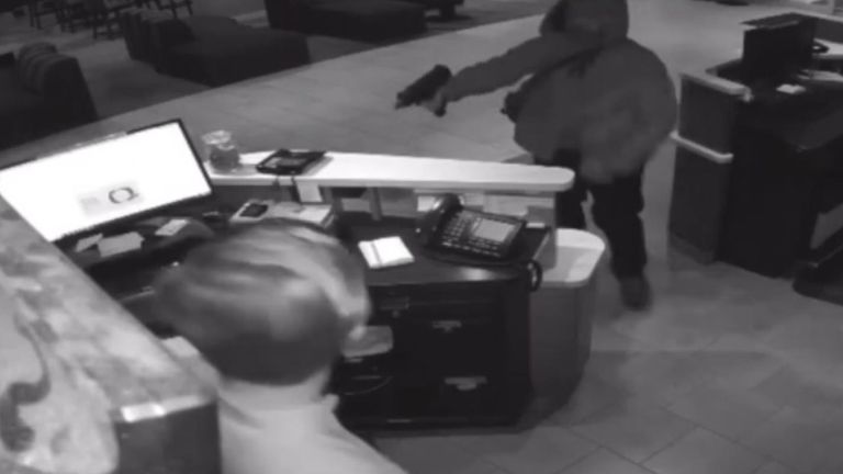 CCTV footage captures moment an armed robber raided an hotel in Atlanta and held up a receptionist. Pic: City of Atlanta PD