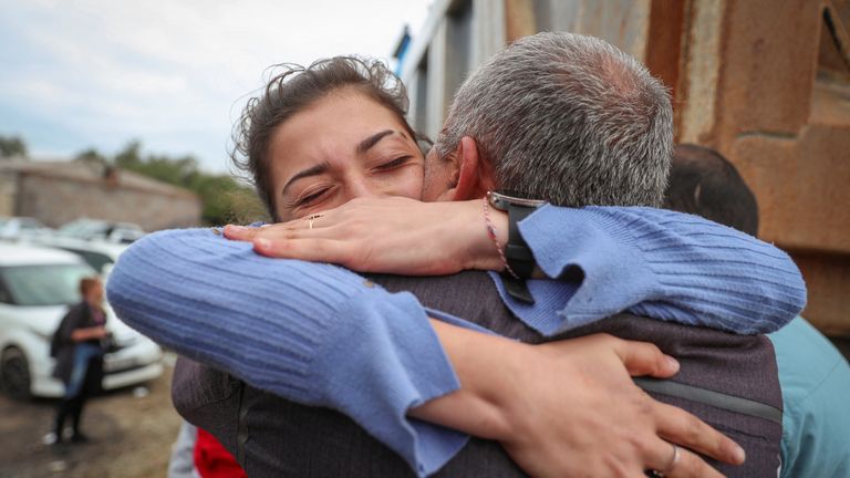 Refugee from Nagorno-Karabakh region Karine Djagaryan hugs her father Novlet Djagaryan as they meet in the border village of Kornidzor, Armenia, September 26, 2023. REUTERS/Irakli Gedenidze
