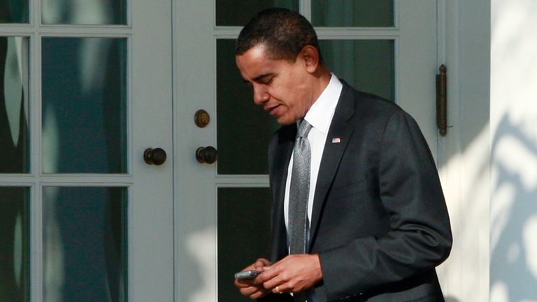 U.S. President Barack Obama uses a Blackberry device as he makes his way toward the Oval Office at the White House in Washington, January 29, 2009. Obama was allowed to keep the Blackberry after security modifications were made. REUTERS/Jason Reed (UNITED STATES)