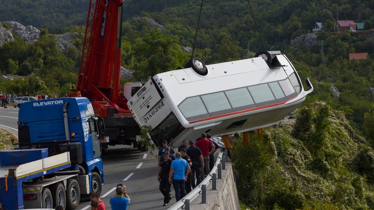 Rescue workers hoisting the bus out of the ravine near Cetinje, Montengro Pic: AP 