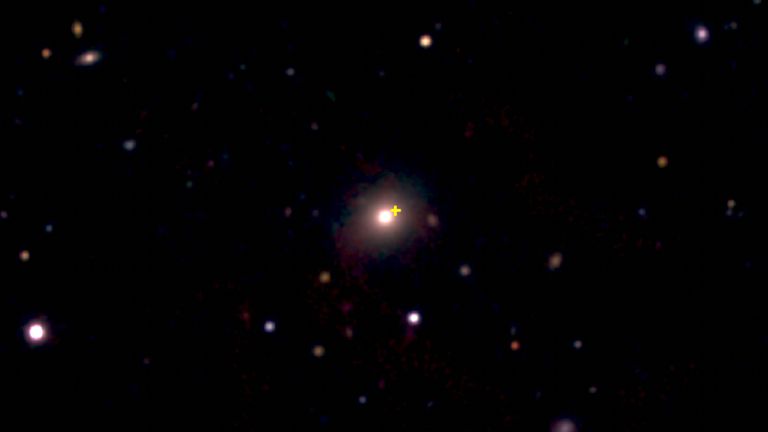An image from the European Southern Observatory New Technology Telescope showing a distant red galaxy (centre) where a cosmic explosion occurred. Pic: Queen&#39;s University Belfast