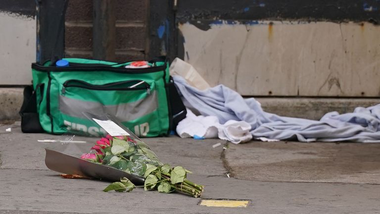 Flowers at the scene  as forensic investigators  work the scene in Croydon