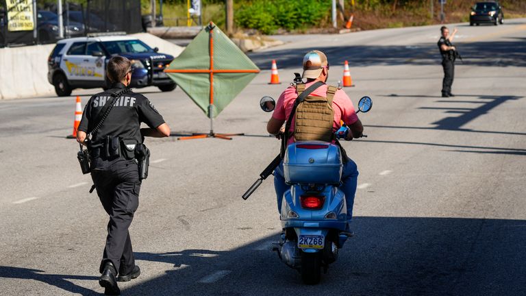 An armed man drives past police  as the search for escaped convict Danelo Cavalcante continues in Pottstown
Pic:AP