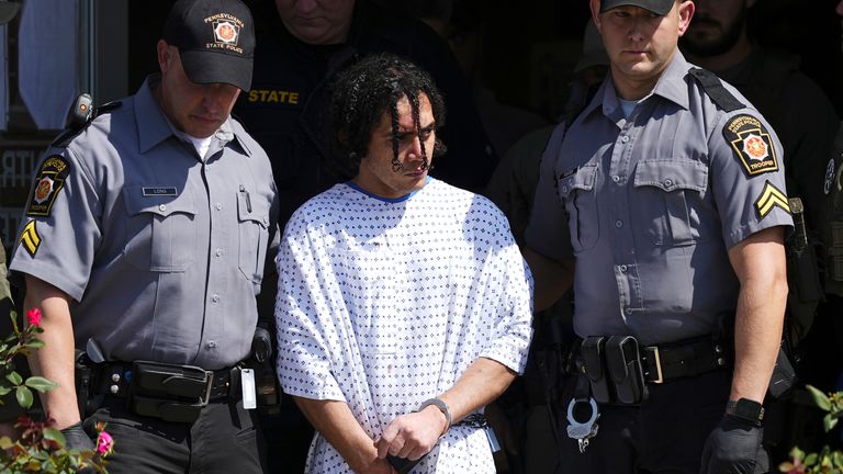 Officers escort Danelo Cavalcante from a Pennsylvania State Police barracks. Pic: AP