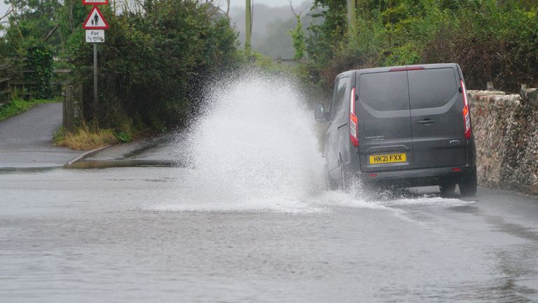 A van is driven through floodwater on a road in to Dawlish, Devon. Picture date: Wednesday September 20, 2023.