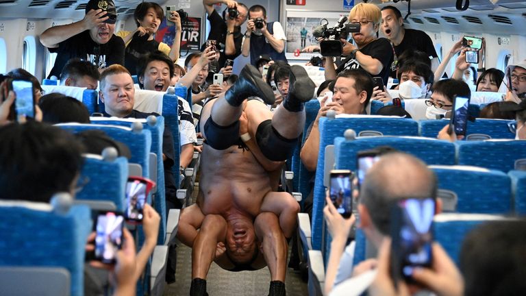 Minoru Suzuki and Sanshiro Takagi, wrestlers from Japanese professional wrestling promotion DDT Pro-Wrestling, fight inside Tokaido Shinkansen bullet train from Tokyo to Nagoya during a wrestling show in Japan September 18, 2023, in this handout photo released by JR Tokai (The Central Japan Railway Company). JR Tokai/Handout via REUTERS ATTENTION EDITORS - THIS IMAGE HAS BEEN SUPPLIED BY A THIRD PARTY. MANDATORY CREDIT. NO RESALES. NO ARCHIVES. TPX IMAGES OF THE DAY

