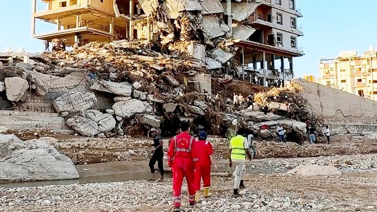 Emergency members work near a damaged building after a powerful storm and heavy rainfall hit Libya, in Derna 
Pic:Ali M.Bomhadi/Reuters