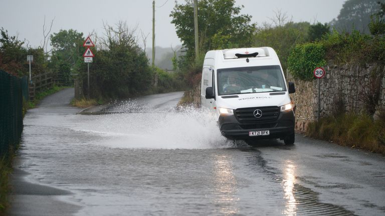 A van is driven through floodwater on a road in to Dawlish, Devon. Picture date: Wednesday September 20, 2023.