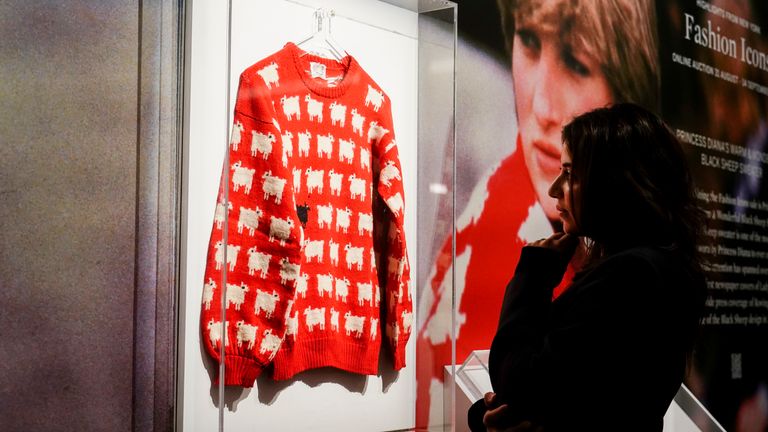 Nezha Bernoussi, marketing and communication associate at Sotheby&#39;s looks at Princess Diana&#39;s jumper on display
