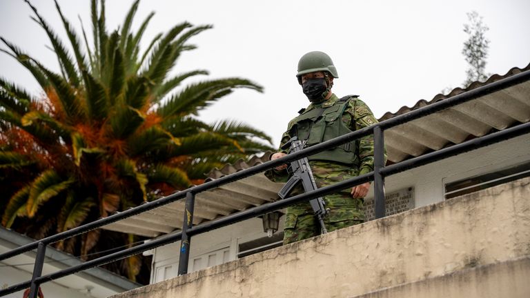 A soldier guards a polling station during a presidential election in Quito, Ecuador, Sunday, Aug. 20, 2023. The special election was called after President Guillermo Lasso dissolved the National Assembly by decree in May to avoid being impeached.(AP Photo/Carlos Noriega)